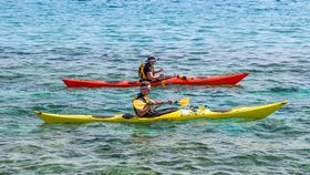 two people canoeing on a river