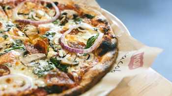 crusty pizza with onion spinach