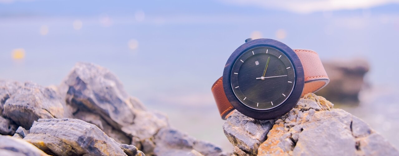 A waterproof watch sitting on a beach