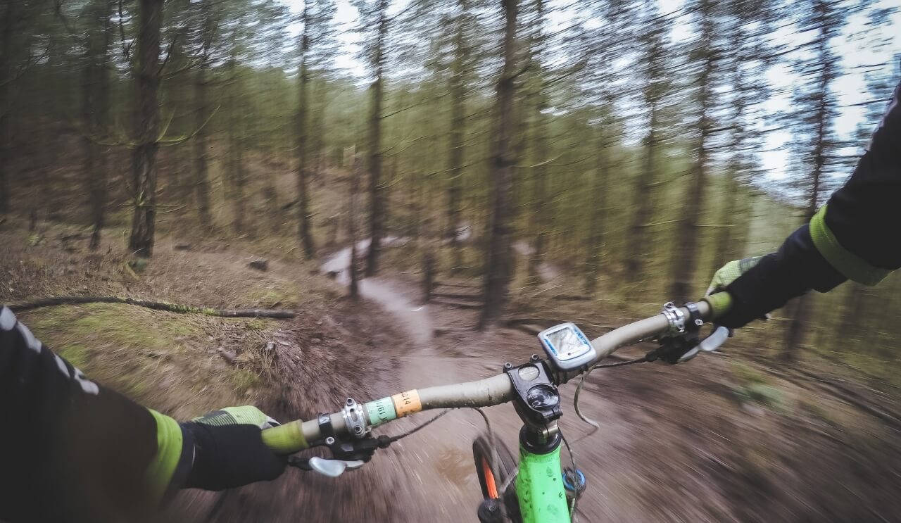 A mountain biker going down a hill