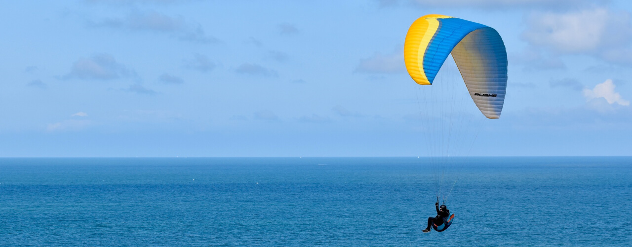 A paraglider above the sea