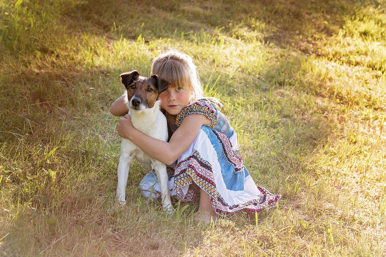 A young girl hugging a dog