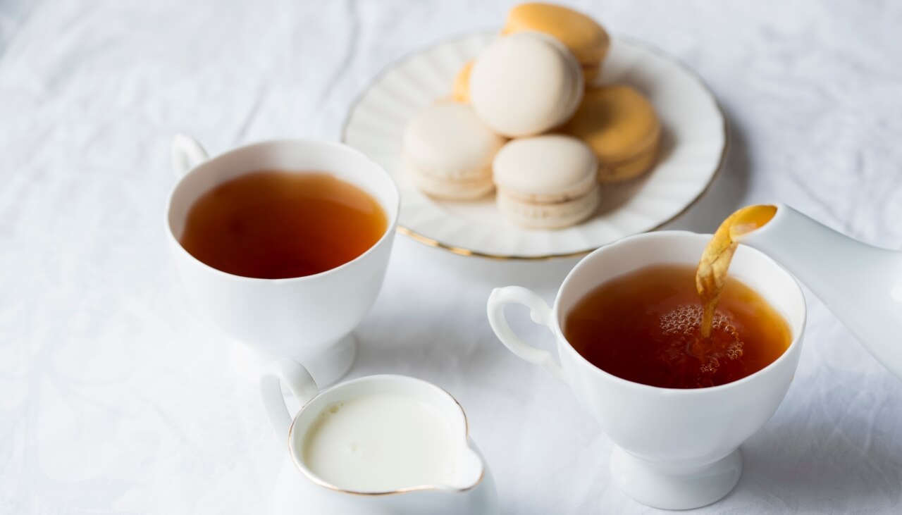 Two cups of tea and some macarons