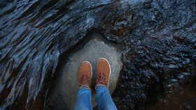 pair of feet in a cave terrain